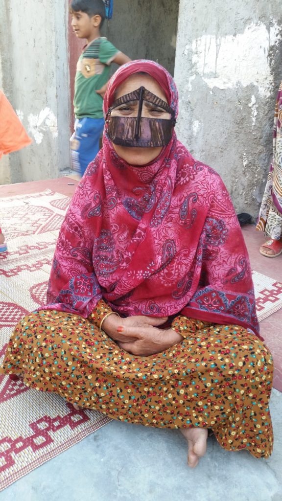Friendly Bandari Woman with traditional mask.